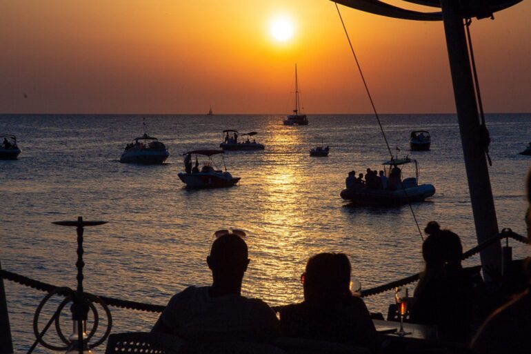 San Antonio Sunset Strip Ibiza 2025 sunset over waterfront bar terraces