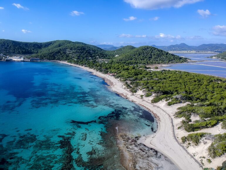 Ses Salines beach clubs Ibiza 2025 natural sand dunes and clear sea